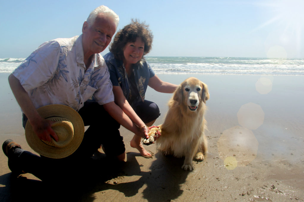 Jeanne and Rick Jackson on the beach with Sunny